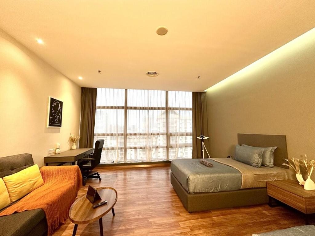 a bedroom with a bed and a couch and a desk at Bangsar Trade Centre By WeCare in Kuala Lumpur