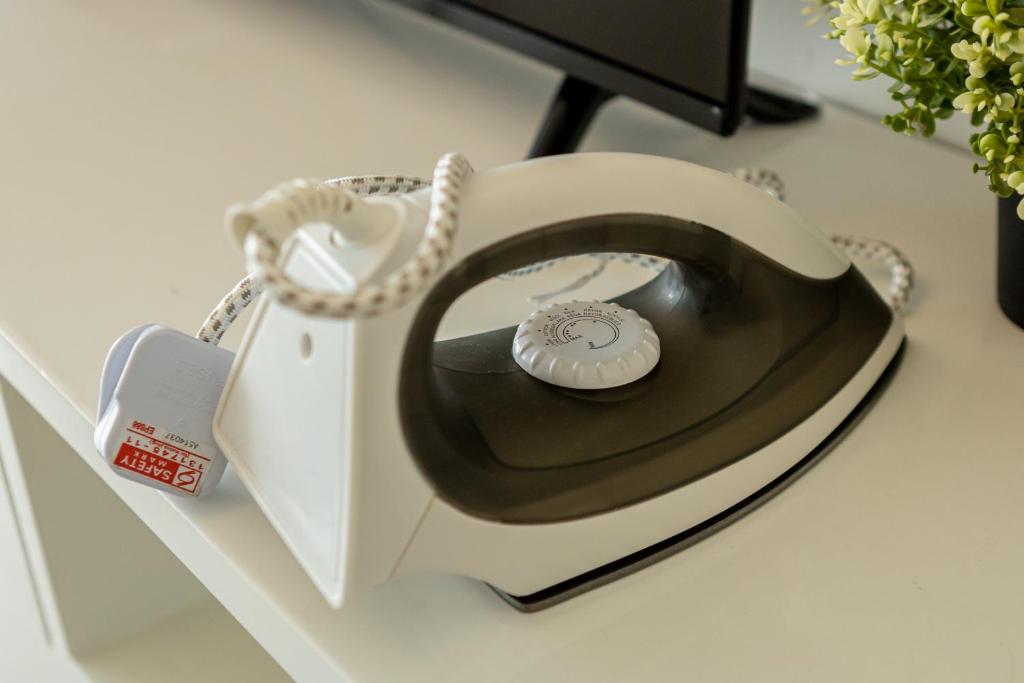 a white phone sitting on top of a desk at Landmark Katana, by BAYAN in Tanjong Tokong