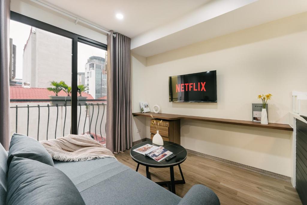 a living room with a couch and a large window at Train Street Lux Homestay in Hanoi