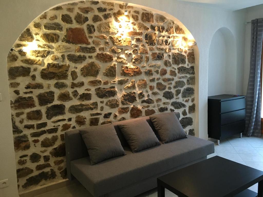a stone wall with a couch in a living room at Residence Villa Ange in La Seyne-sur-Mer