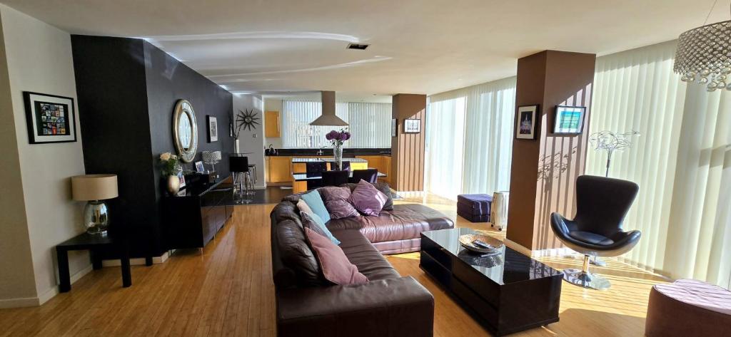 a living room with a couch and a table at Luxury Apartment Best location in Liverpool city center in Liverpool