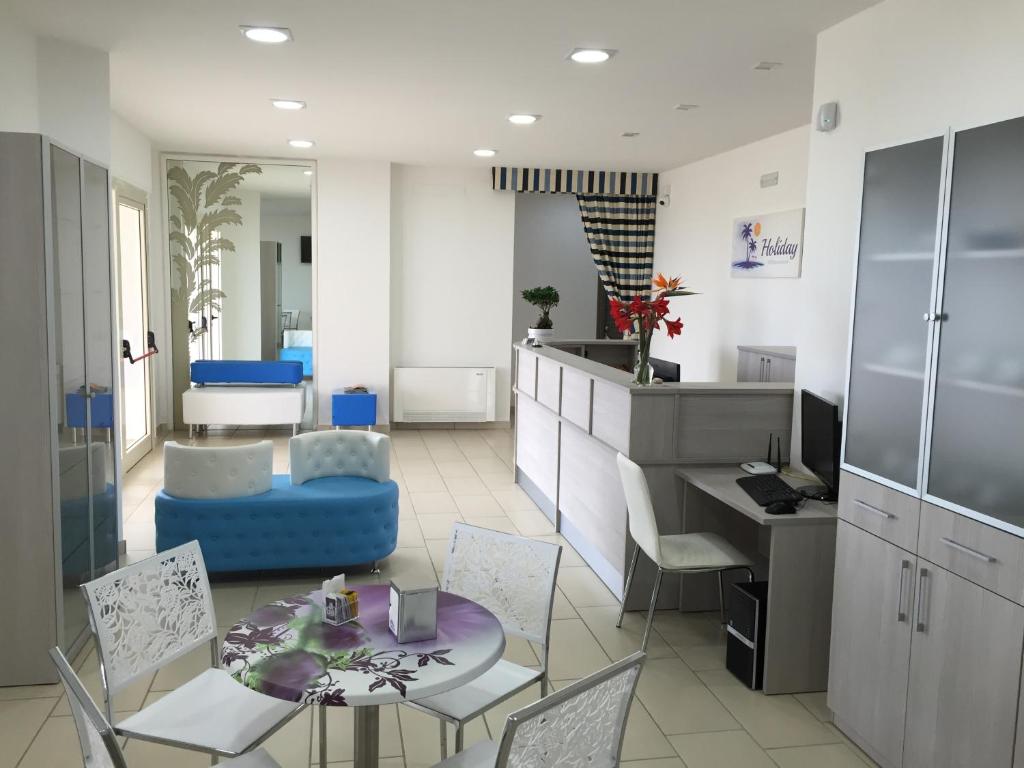 cocina y sala de estar con mesa y sillas en Holiday Affittacamere en Corigliano Calabro