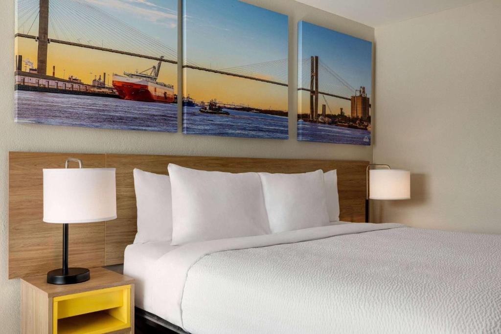 a hotel room with a bed and a bridge at Days Inn by Wyndham Emporia in Emporia