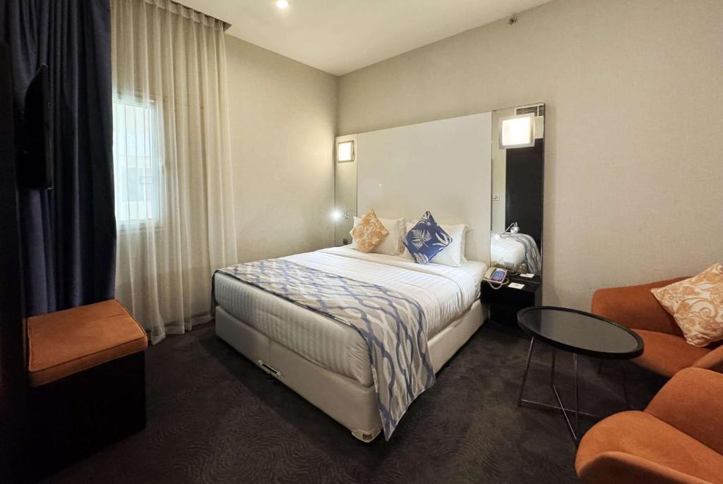 Voodi või voodid majutusasutuse Ramada Encore Doha by Wyndham toas