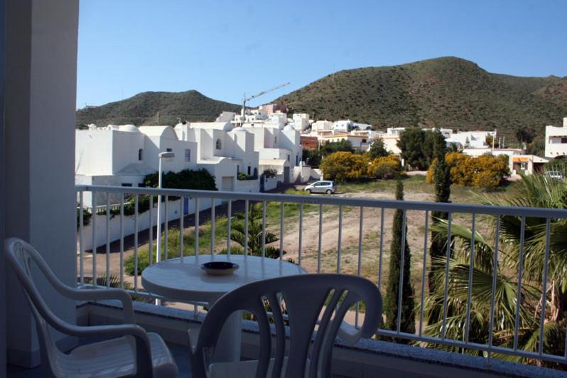 a balcony with a table and chairs and a view of a city at Hostal Brisamar in San José
