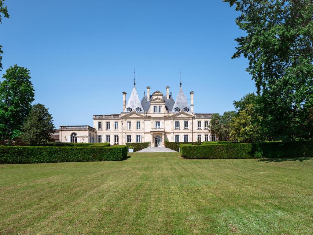 a large house with a large yard in front of it at Château de Lussac in Lussac