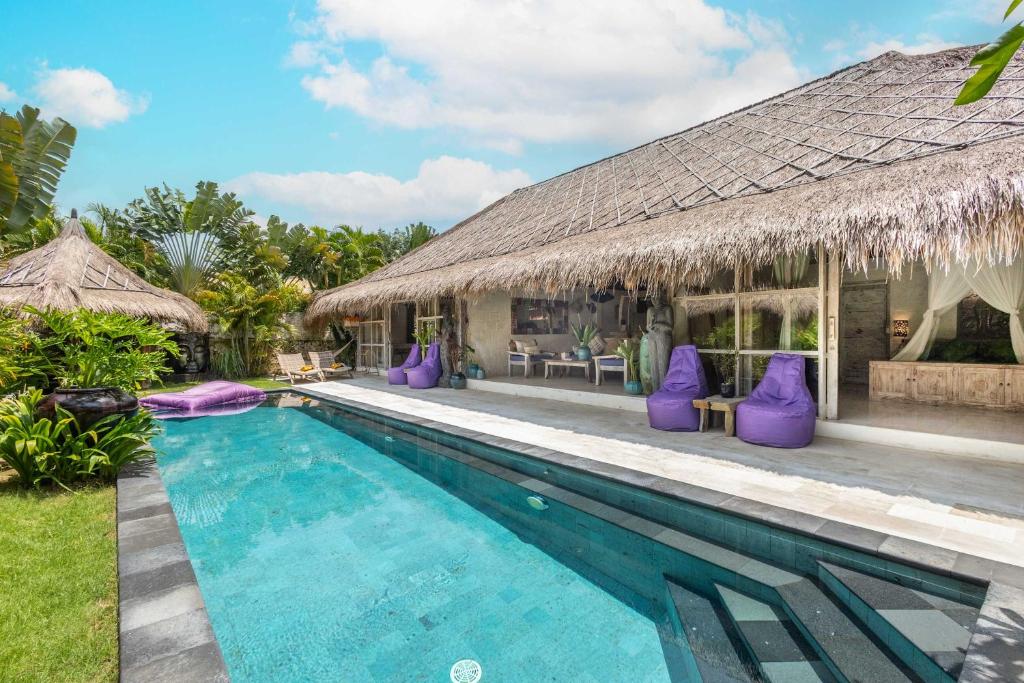 a villa with a swimming pool and a resort at Megalan Villa Balangan in Badung