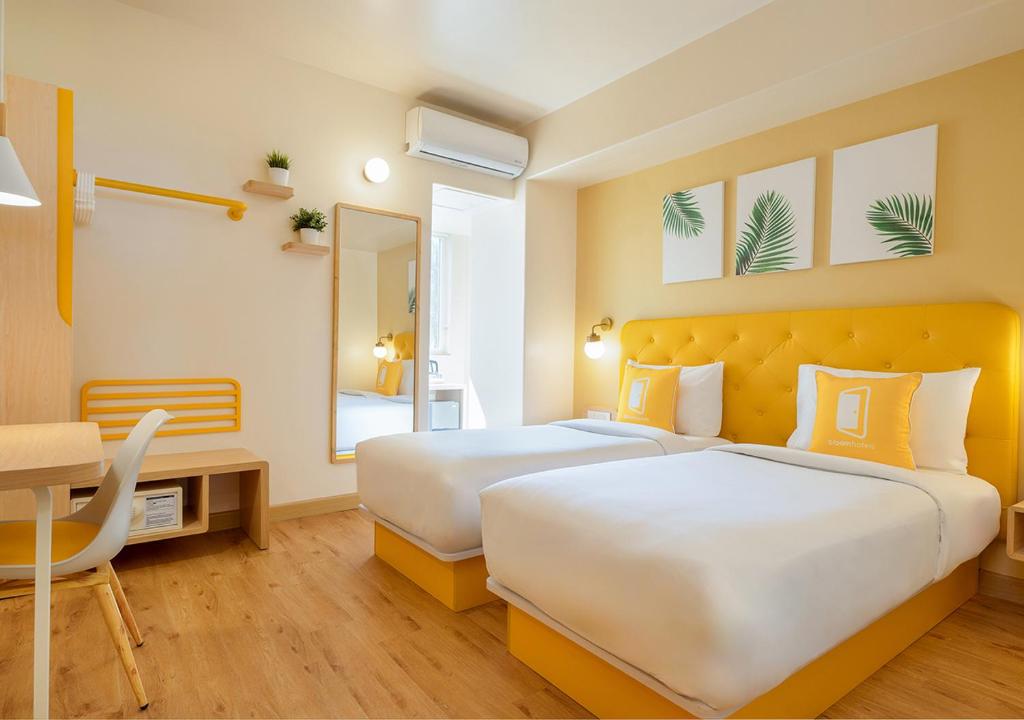 Postel nebo postele na pokoji v ubytování Bloom Hotel - Jayanagar