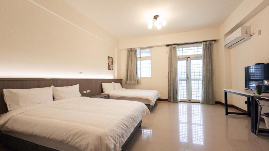 Postel nebo postele na pokoji v ubytování Yearning Homestay