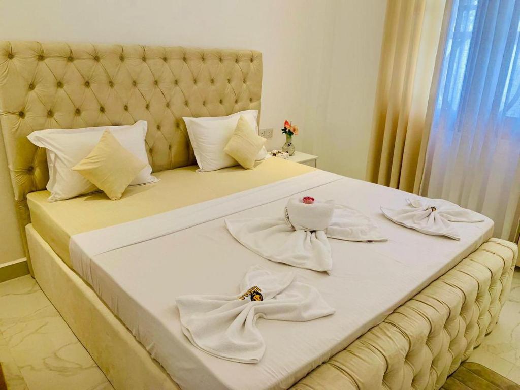 a large white bed with white towels on it at Dikckwella Luna villa in Dickwella