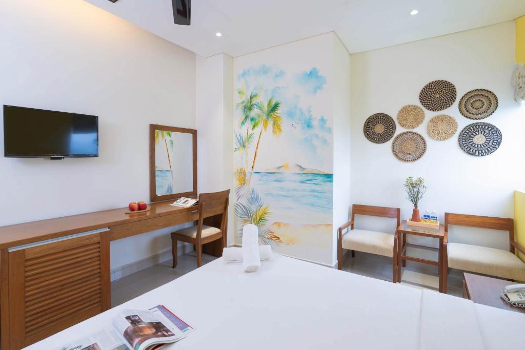 Televiisor ja/või meelelahutuskeskus majutusasutuses Doha Central Bliss Danang Hotel by Haviland