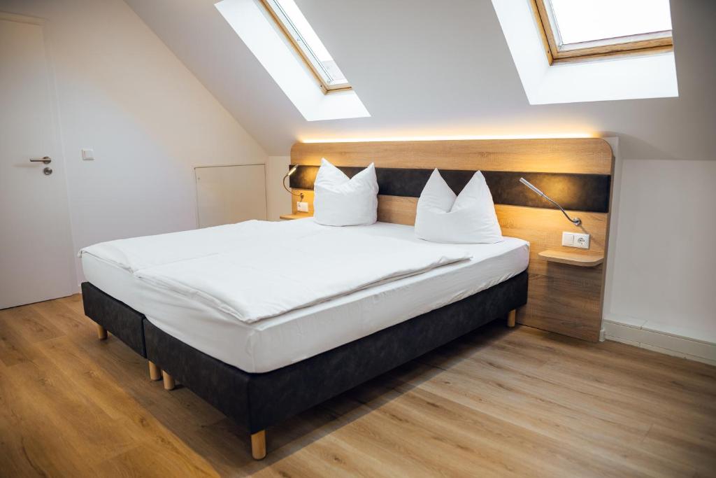 una camera da letto con un grande letto con cuscini bianchi di Palais a Erfurt