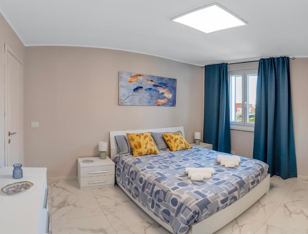 a bedroom with a bed with blue curtains at Alloggio turistico metro C in Borghesiana 