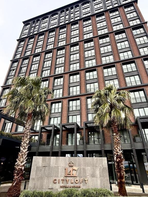 a large building with palm trees in front of it at Cityloft 147 in Istanbul