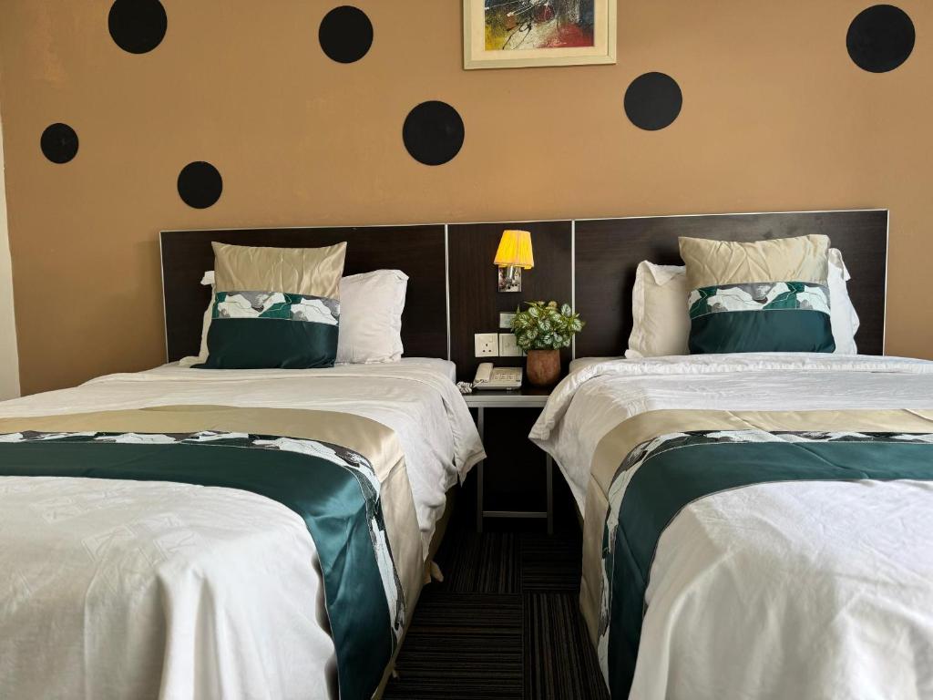 Postel nebo postele na pokoji v ubytování K Garden Hotel (BS)