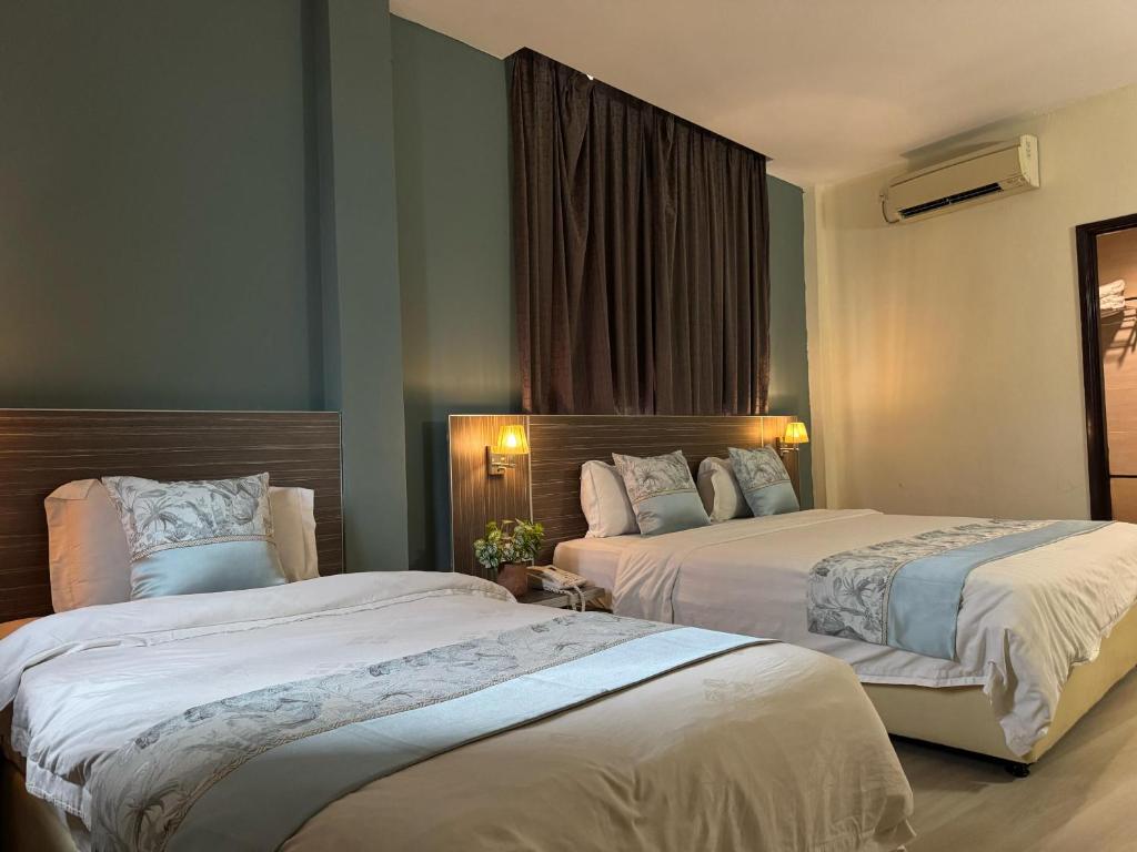Postel nebo postele na pokoji v ubytování K Garden Hotel (BS)
