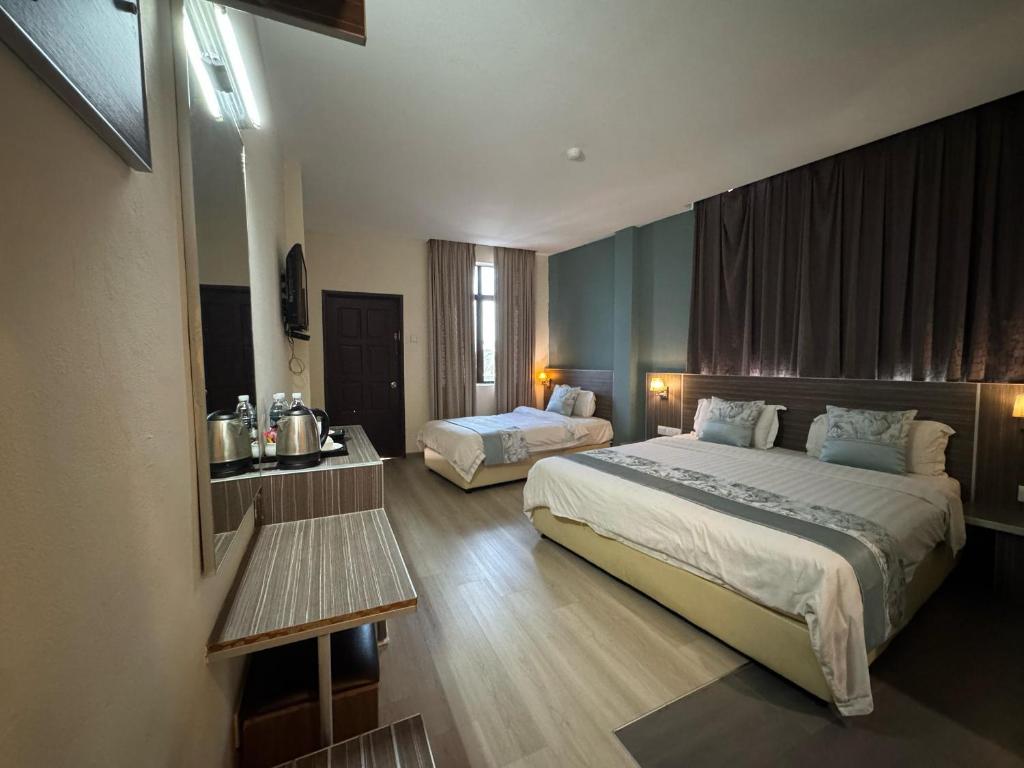 Postel nebo postele na pokoji v ubytování K Garden Hotel (BS)