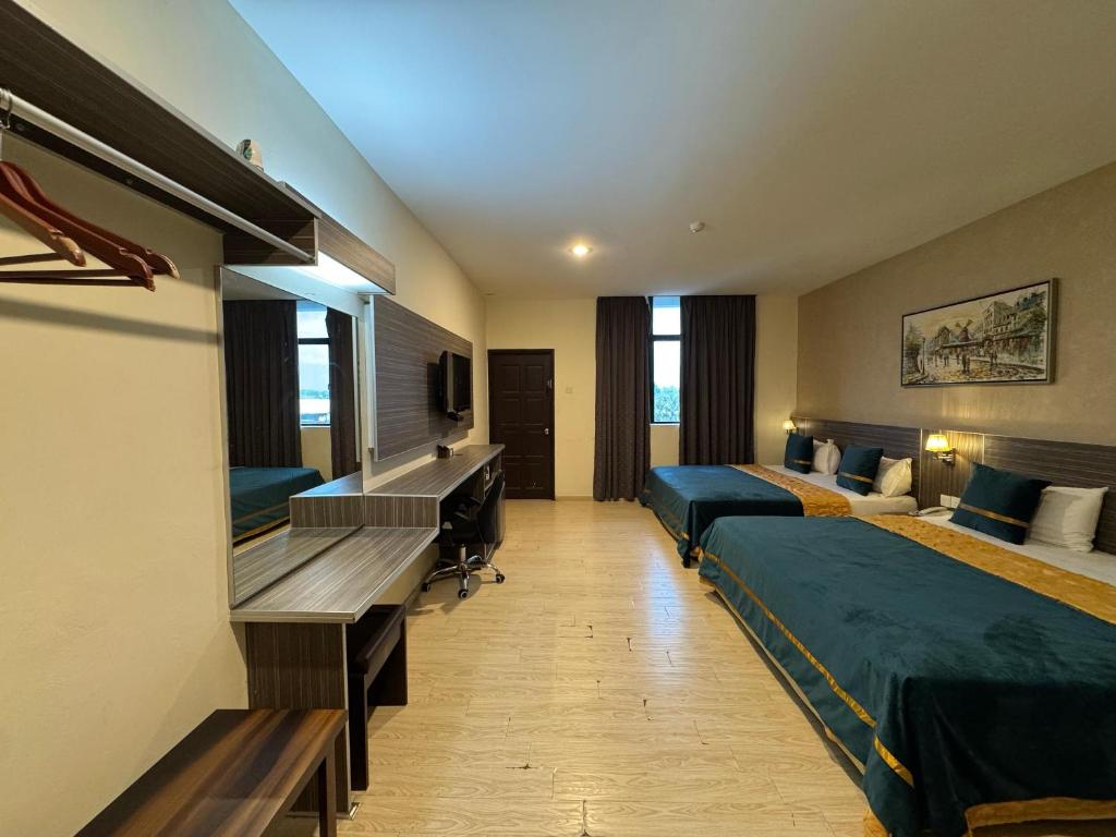 Postel nebo postele na pokoji v ubytování K Garden Hotel (BS)