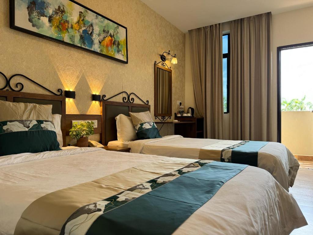 Postel nebo postele na pokoji v ubytování K Garden Hotel (BS)