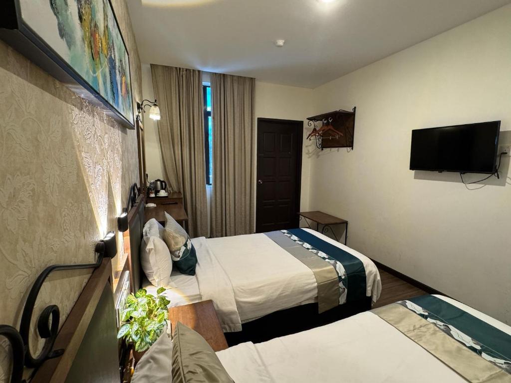 Postel nebo postele na pokoji v ubytování K Garden Hotel (BS)