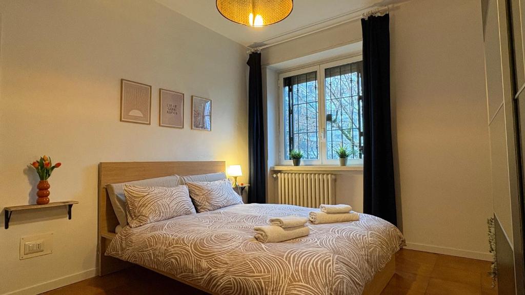 a bedroom with a bed with two towels on it at Niguarda Hospital M5 Lilla 10 Home Away WiFi AC in Milan