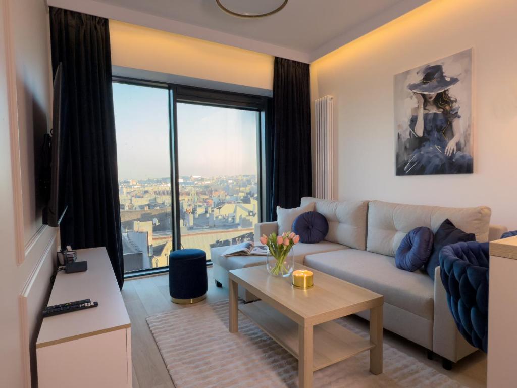 a living room with a couch and a table at URBAN APARTMENTS GLOBAL PREMIUM 8th floor no 16, Free Garage, Self Check-in, No Deposit in Katowice
