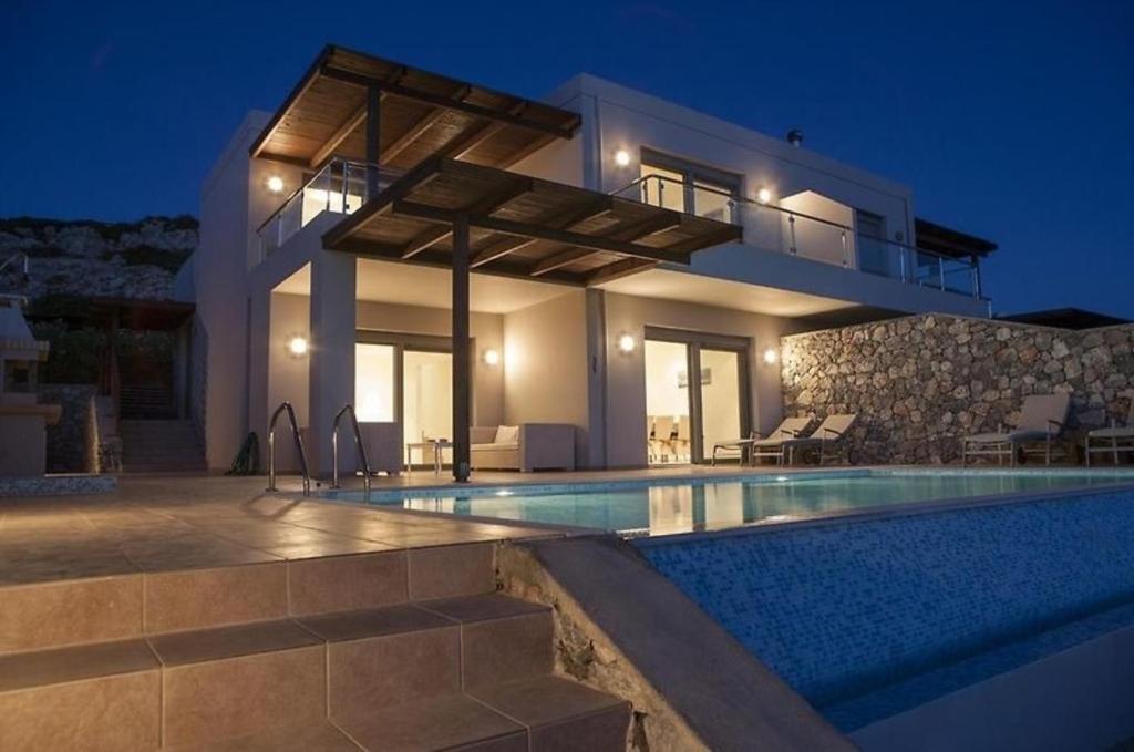 a villa with a swimming pool at night at Pefkos Heights Private Pool Villa in Pefki Rhodes
