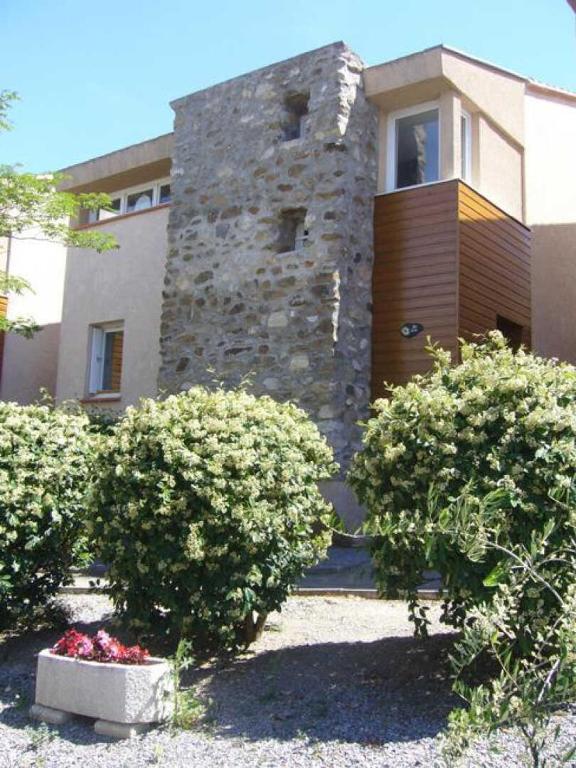 une maison avec deux buissons devant elle dans l'établissement Lou soula, à Trilla