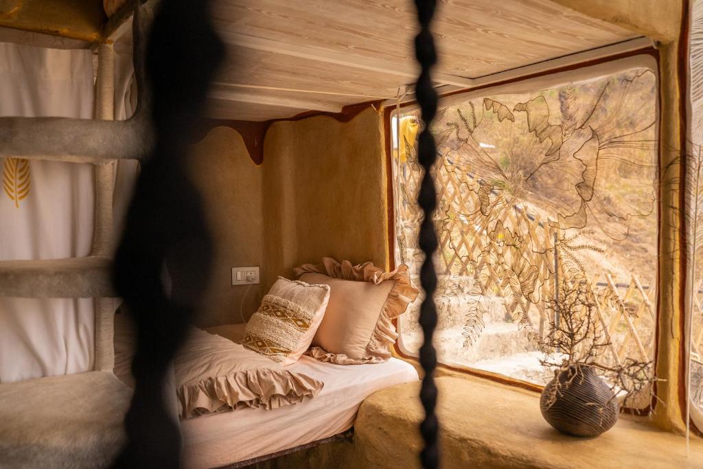a bed in a room with a window at Paarli Dhara capsules in Bīr