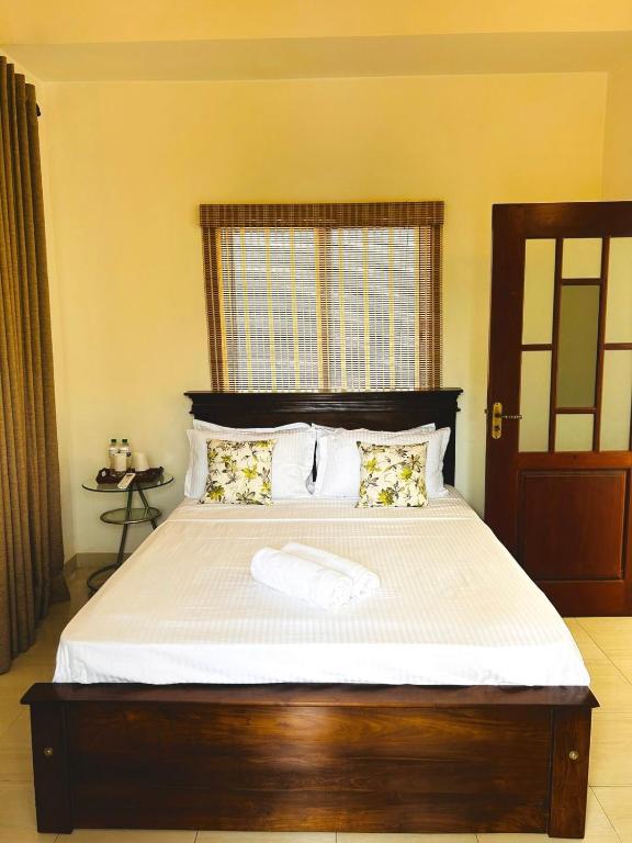 Postel nebo postele na pokoji v ubytování Neem Aura Home Stay