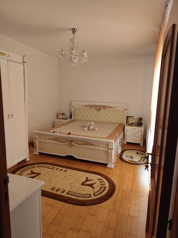 a bedroom with a bed and two rugs on the floor at Vila Elena in Bucharest