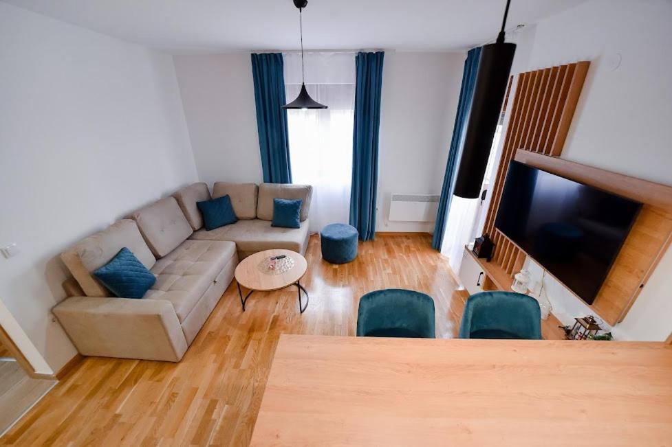 a living room with a couch and a flat screen tv at Gorski Elegance 2 in Zlatibor