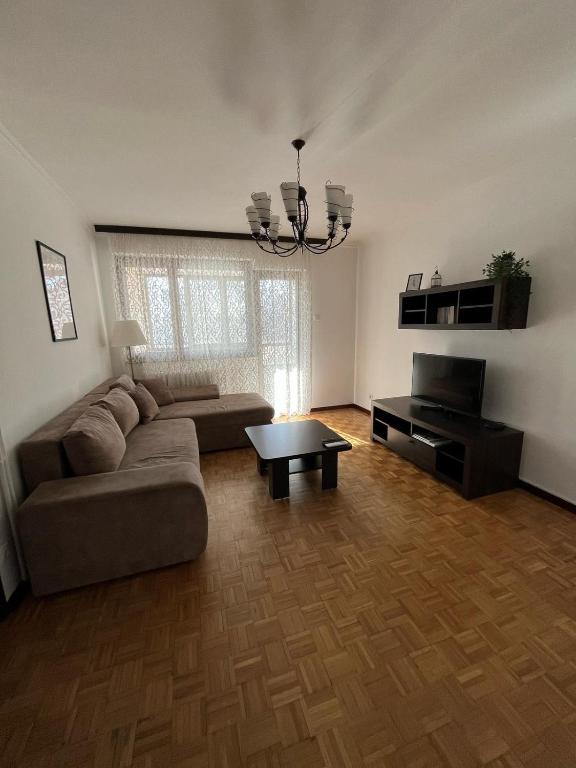 a living room with a couch and a table at Apartman Selaković in Bela Crkva