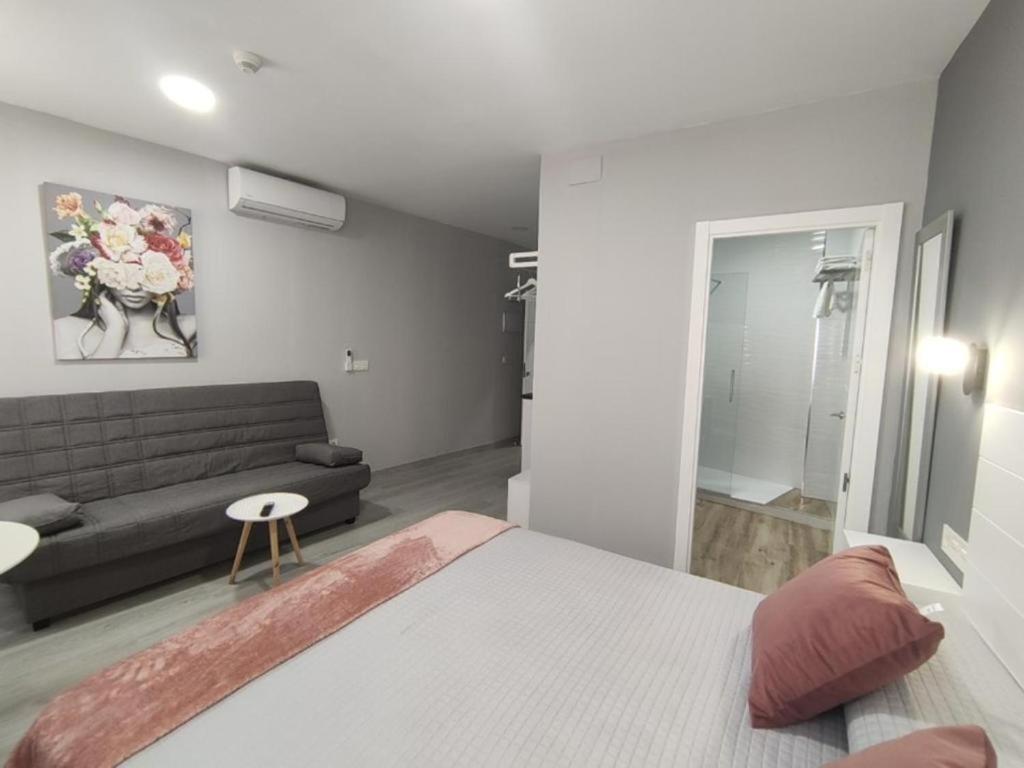 Posteľ alebo postele v izbe v ubytovaní Apartamentos Harmonia