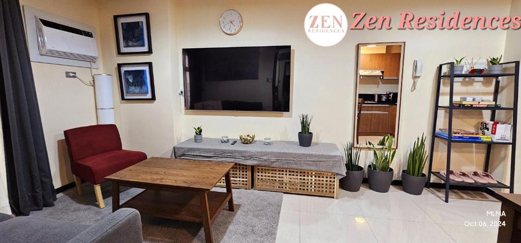 a living room with a table and a tv at Bliss by Zen Residences at The Radiance Manila Bay in Manila
