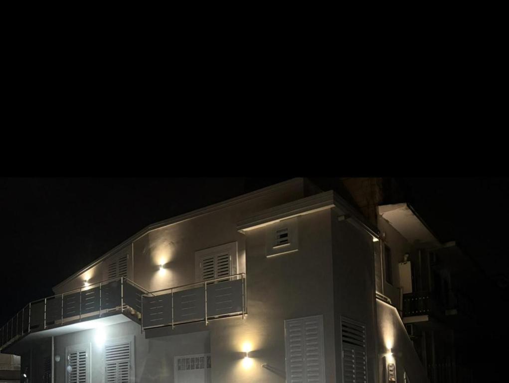 a building with lights on the side of it at night at Dimora Ambrosio 108 in San Giuseppe Vesuviano