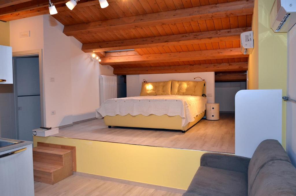 a bedroom with a bed and a wooden ceiling at Residenza La Piazzetta in Porto Recanati