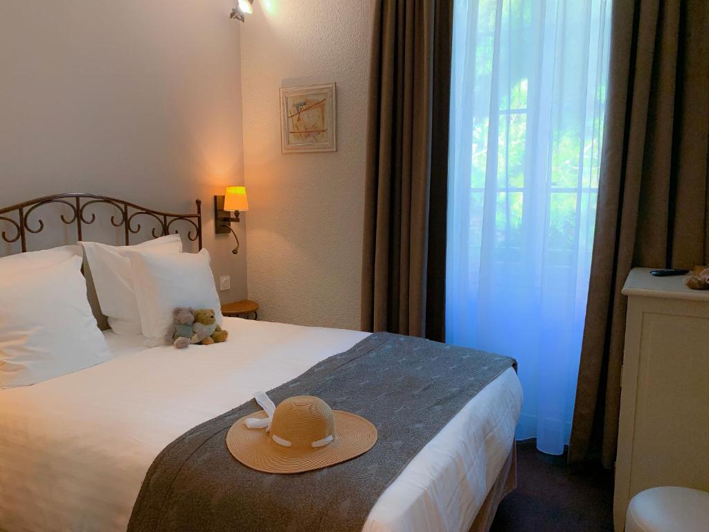 Postel nebo postele na pokoji v ubytování Hôtel de l'Horloge