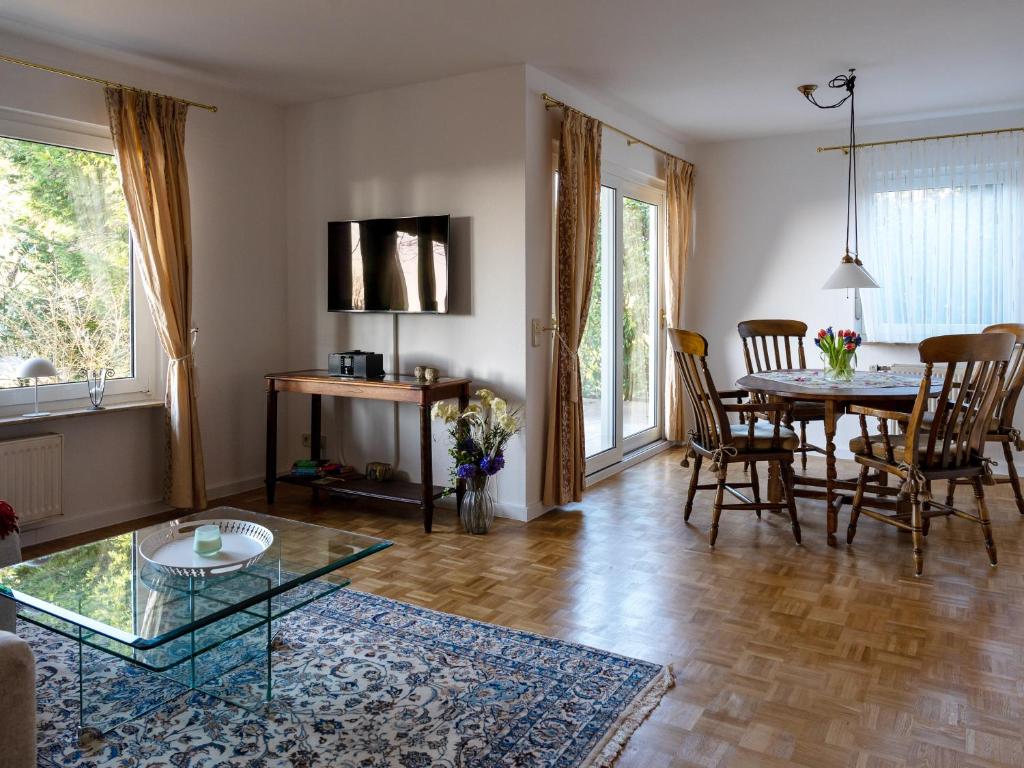 a living room with a table and a dining room at Ferienwohnung am Hochblauen in Badenweiler