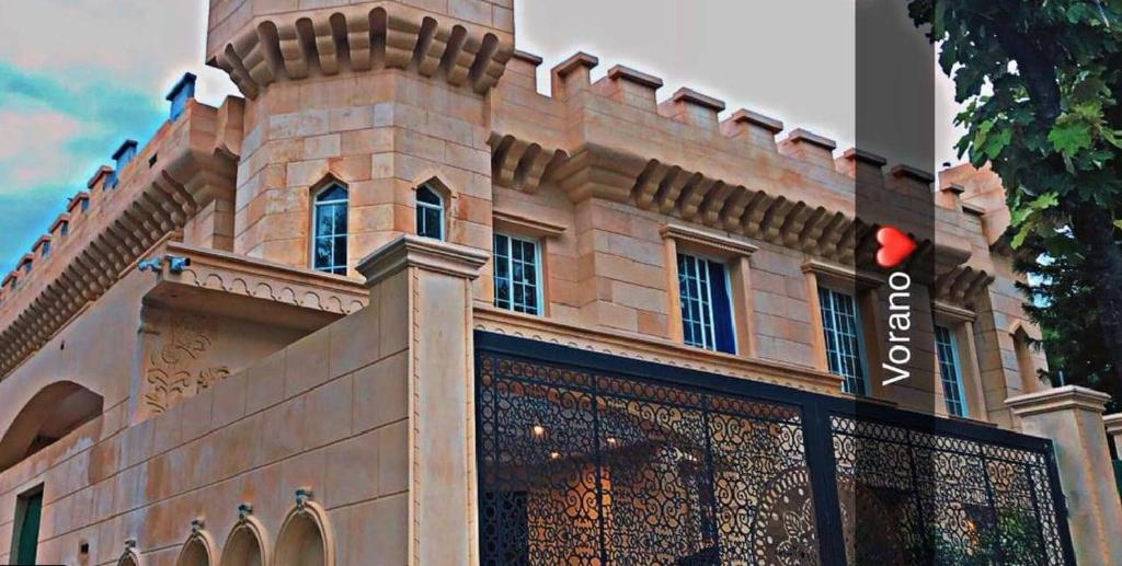 a building with a fence in front of it at Vorano Boutique Hotel Islamabad in Islamabad