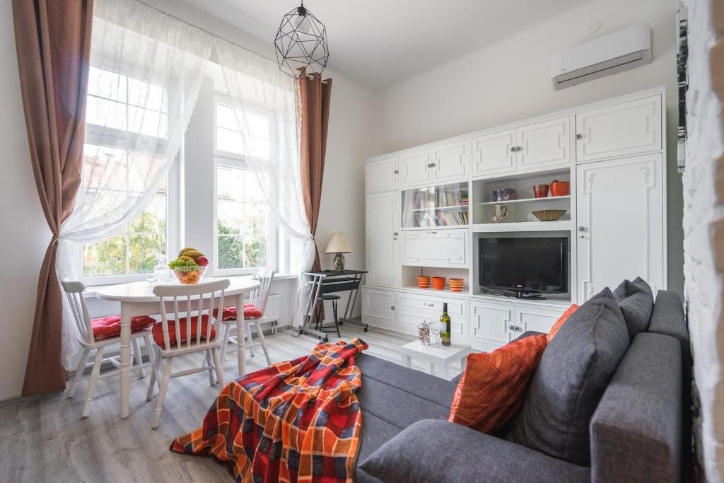 a living room with a couch and a table at Katica's Ribnjak Retreat in Zagreb