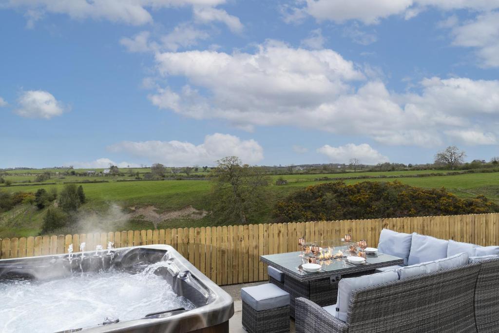 a hot tub on a patio with a table and chairs at HC Property - The Hideaway at Watergate Eye in Durham