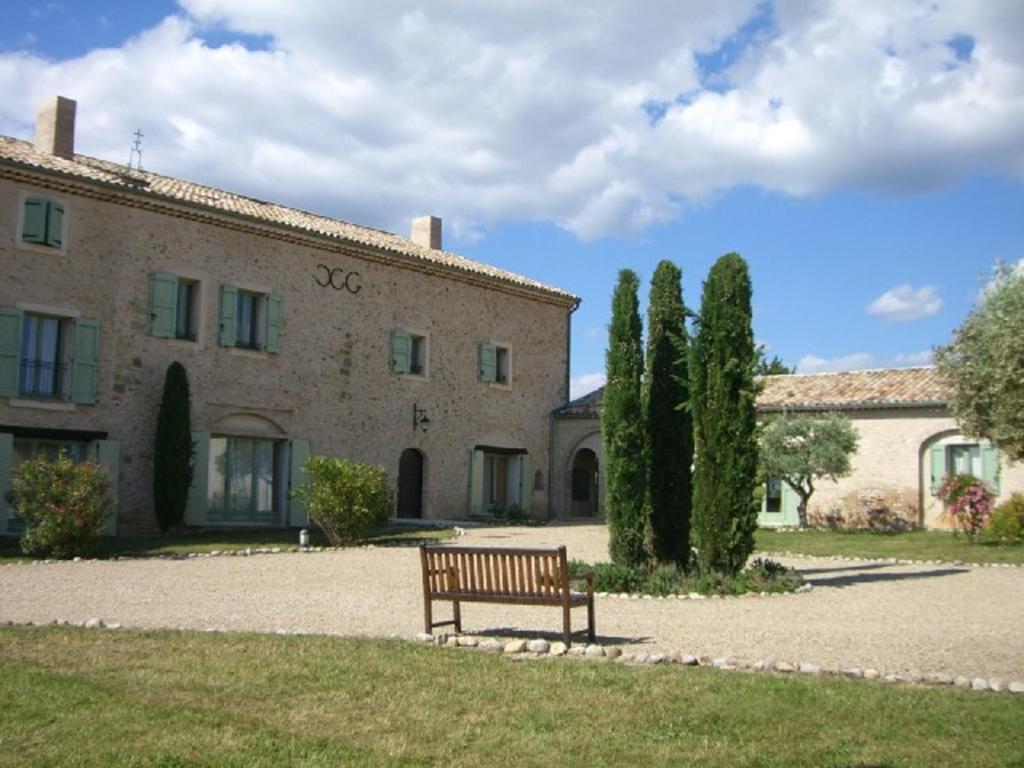 un banc assis devant un bâtiment dans l'établissement Gîte familial confortable au cœur de Valensole - FR-1-822-8, à Brunet