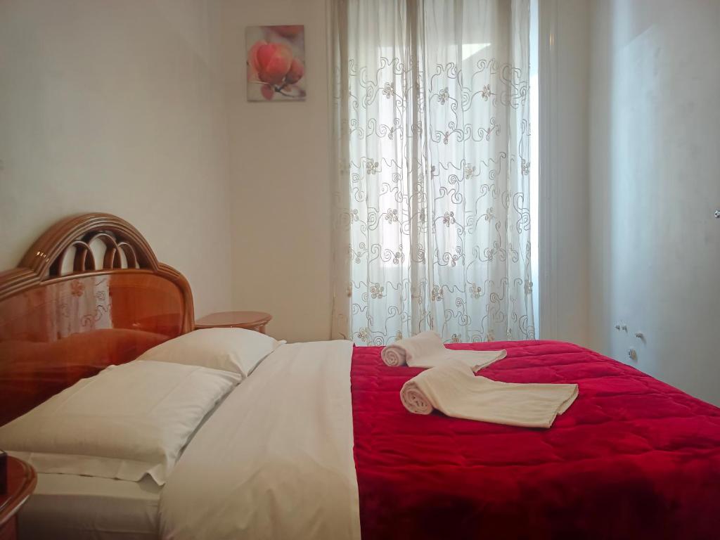 a bedroom with a bed with two towels on it at Fatima House in Rome