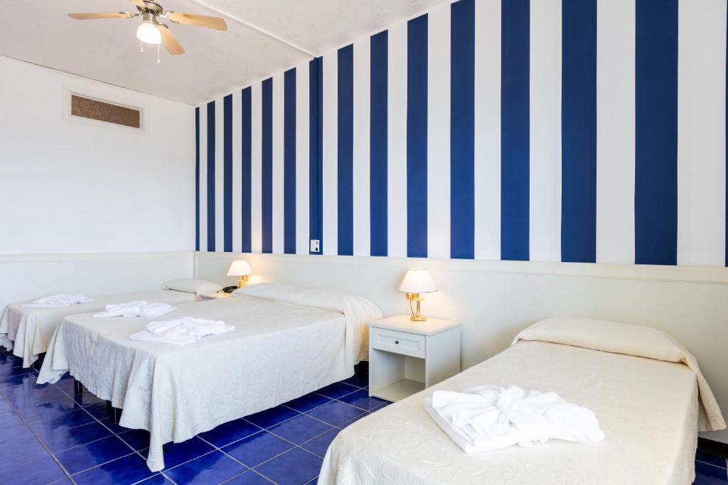 Postel nebo postele na pokoji v ubytování Hotel Caravelle