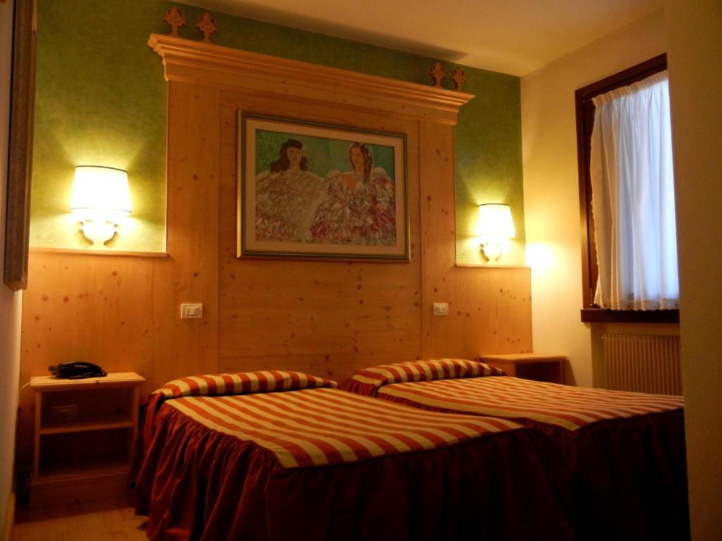 Postel nebo postele na pokoji v ubytování Albergo Da Gildo