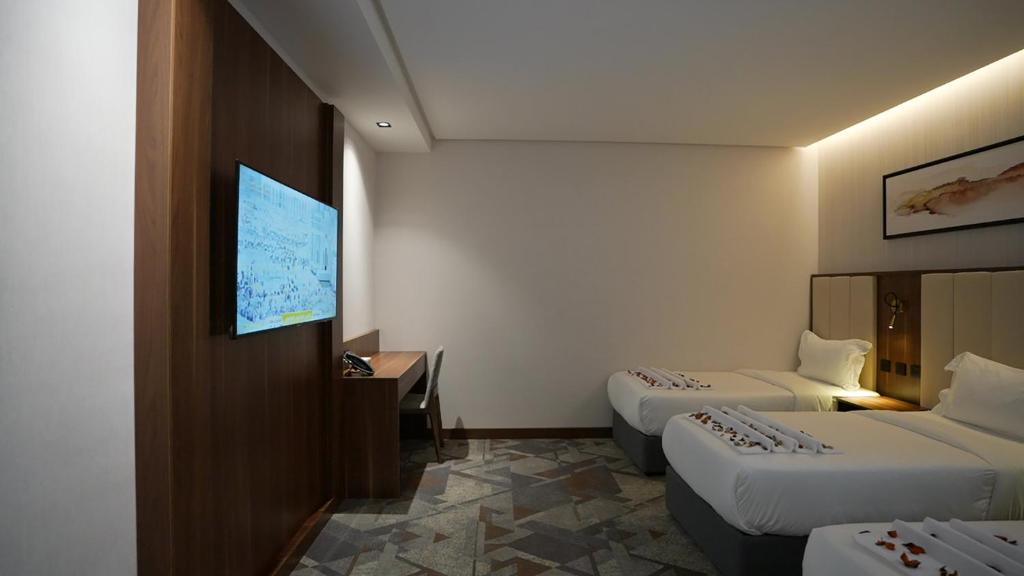 TV a/nebo společenská místnost v ubytování Ajm Mina Hotel