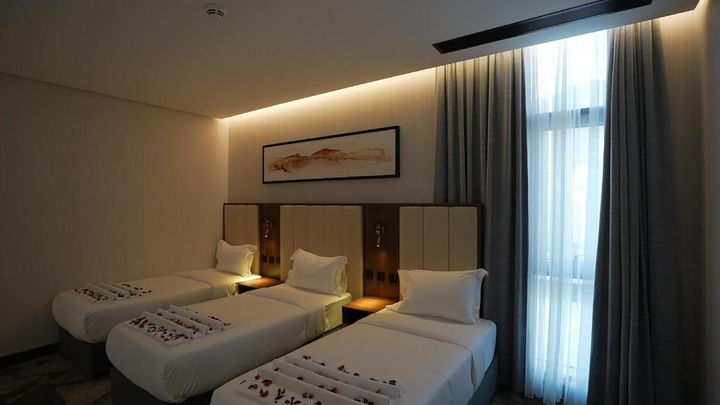 Postel nebo postele na pokoji v ubytování Ajm Mina Hotel