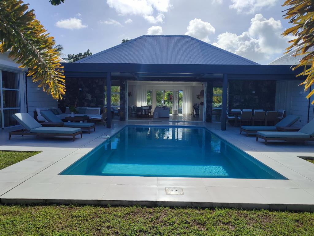 a swimming pool in the yard of a house at Hill Rock villas - Blue Silver in Petit-Bourg