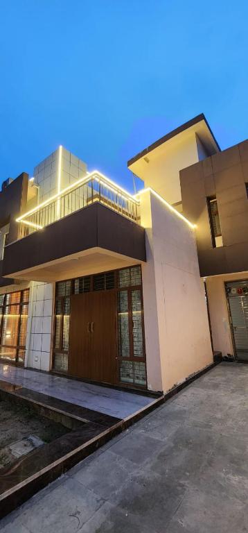 a large building with a balcony on top of it at Rustic Homestay Sonipat in Sonīpat